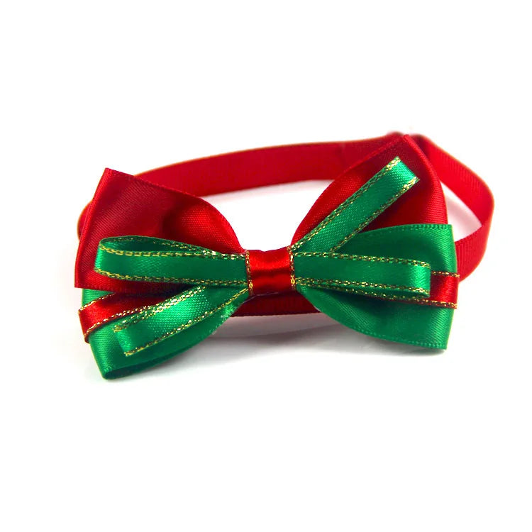 Adjustable SnuggleNest™ Christmas bow tie collar for dogs and cats, featuring festive red and green design.
