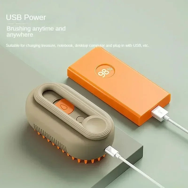 USB rechargeable pet grooming brush and orange power bank on a grey surface