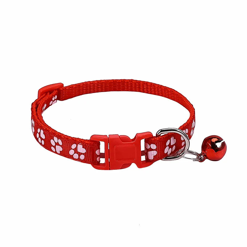 Colorful PawGuard™ pet collar with bell featuring cartoon footprints, adjustable for dogs and cats.