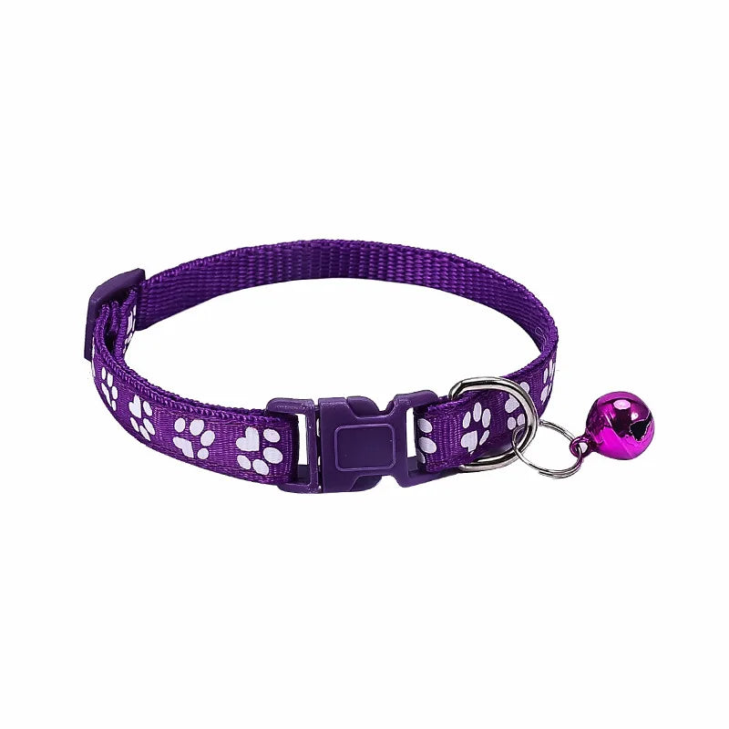 Colorful PawGuard™ pet collar with bell featuring cartoon footprints, adjustable for dogs and cats.