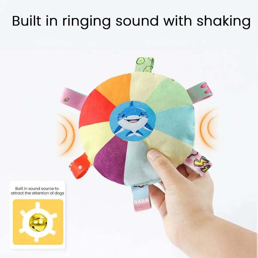 SqueakDisc™ cartoon plush dog toy in vibrant colors, designed for chewing and play with a bell sound feature.