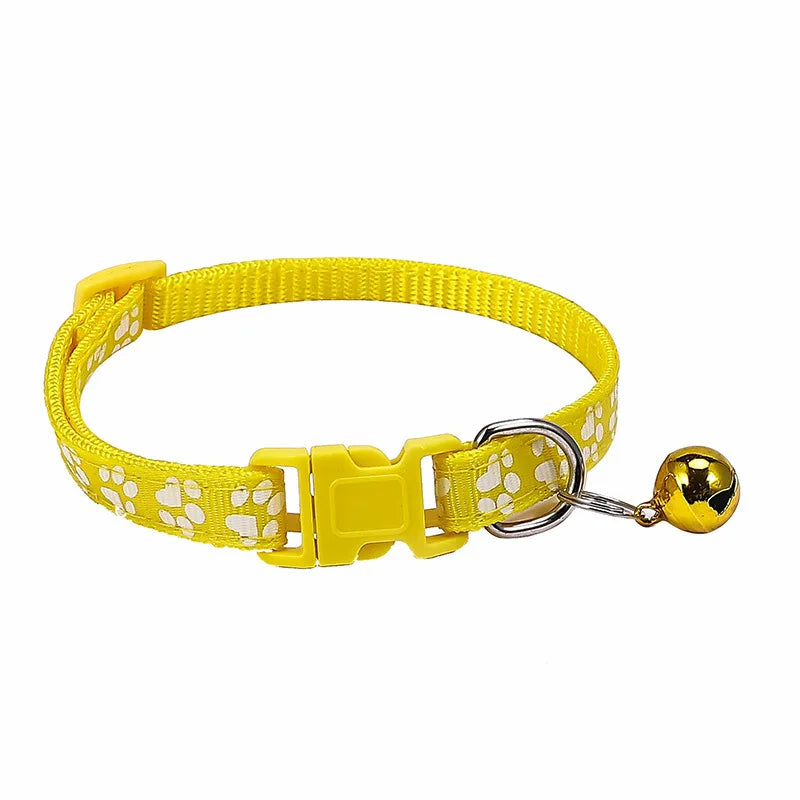 Colorful PawGuard™ pet collar with bell featuring cartoon footprints, adjustable design for dogs and cats.