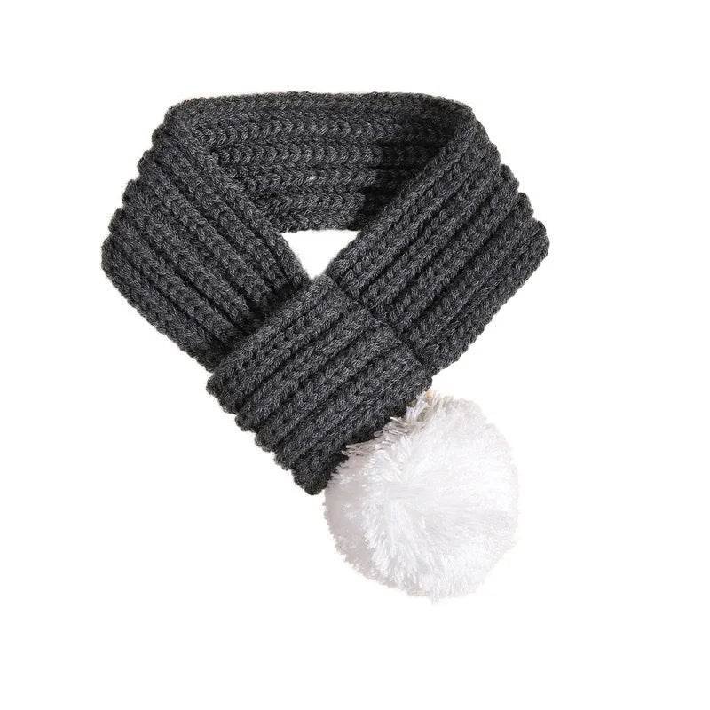 Red knitted scarf with pompom detail for dogs and cats, providing cozy warmth and style from Petivo.