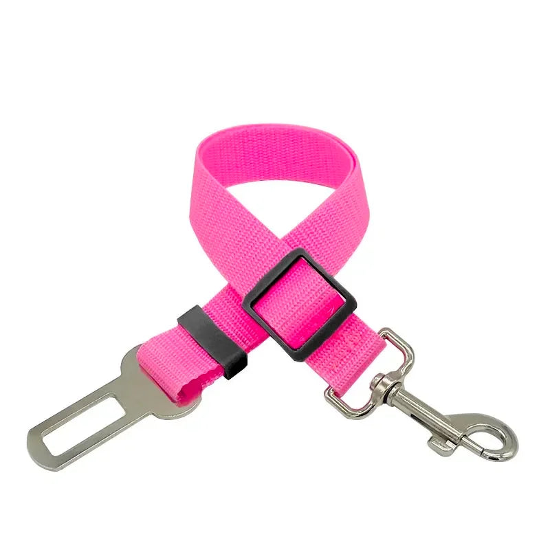 Pink adjustable pet seat belt with metal buckle and leash clip for dog or cat safety in car