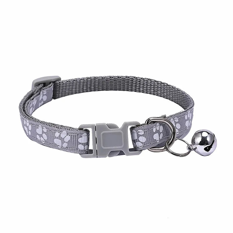 Colorful PawGuard™ pet collar with bell, featuring cartoon footprints, adjustable design for dogs and cats.