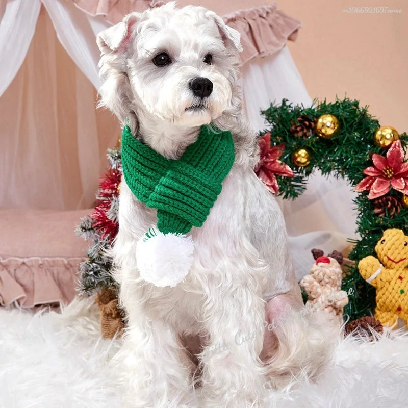 Red knitted pompom scarf for dogs and cats, providing cozy warmth and style for pets during colder weather.