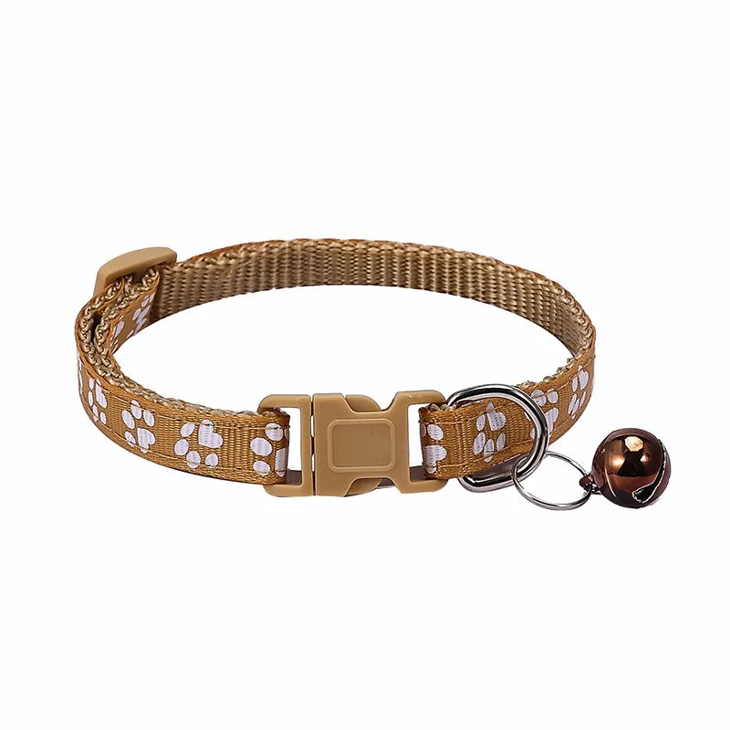Colorful PawGuard™ pet collar with bell featuring cartoon footprints, adjustable design for dogs and cats.