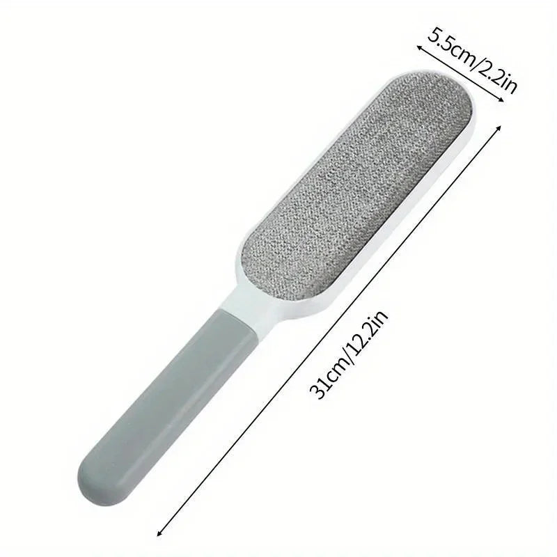 Gray double-sided pet hair remover brush with handle, 31cm by 5.5cm, isolated on white background