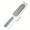 Gray double-sided pet hair remover brush with handle, 31cm by 5.5cm, isolated on white background