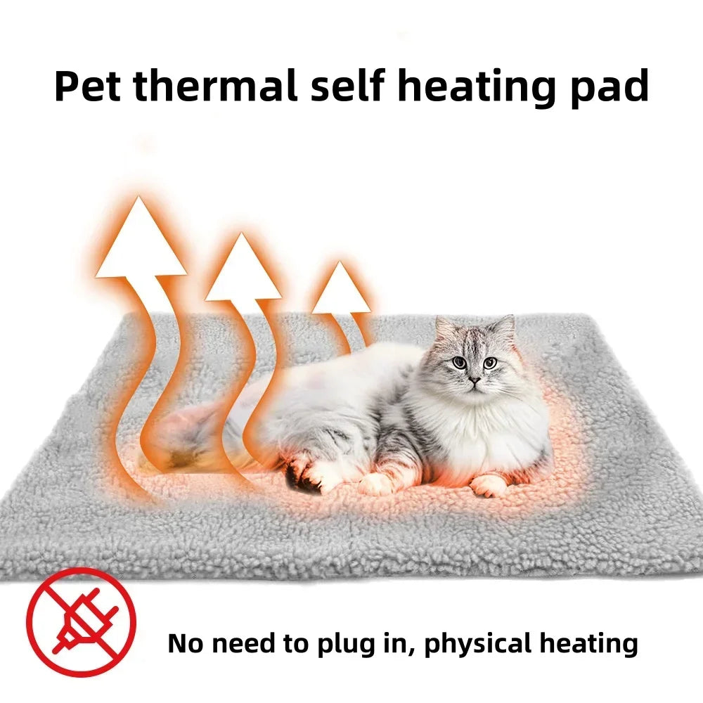 Cat lying on a gray pet thermal self-heating pad with heat arrows, no plug needed.