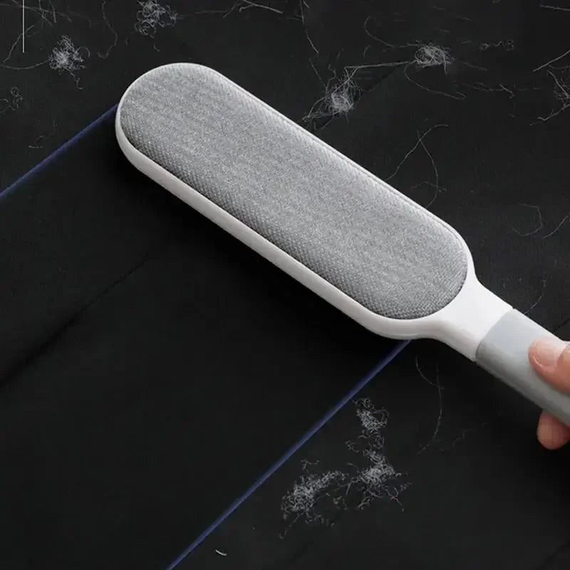 Reusable pet hair remover brush cleaning fur from black fabric surface