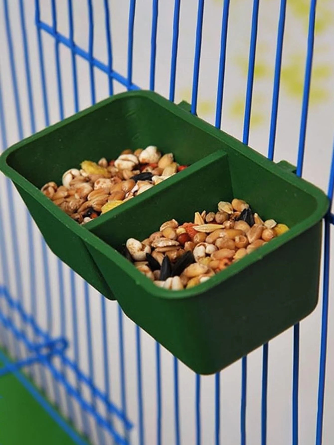 DuoFeed™ 2-in-1 hanging bird feeder with integrated food and water dispensers, designed for space-saving in bird cages.