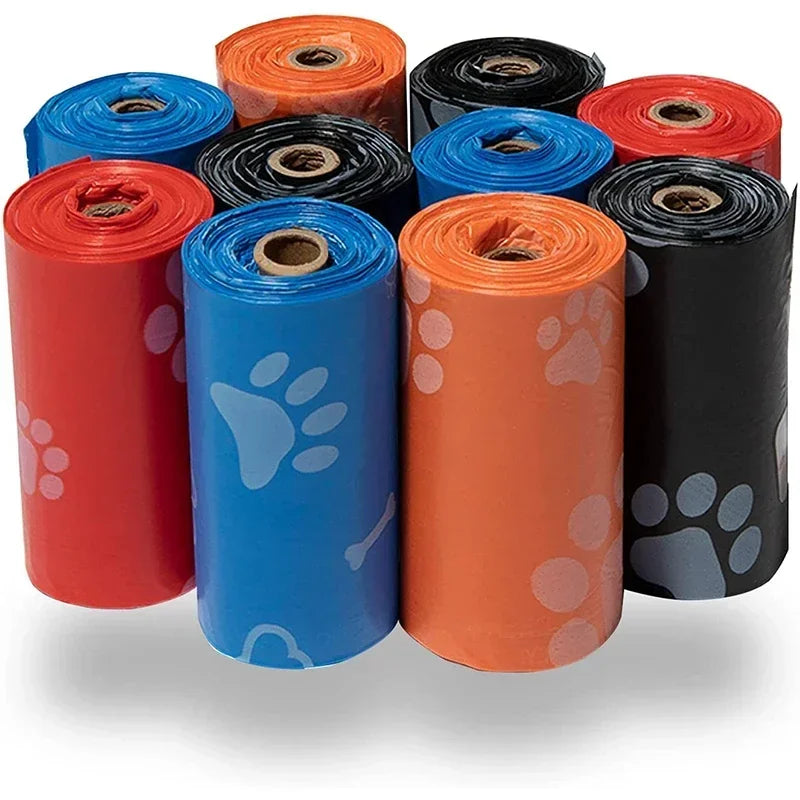 Colorful rolls of dog waste bags with paw print patterns for pet cleanup